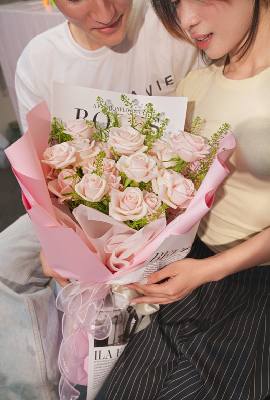 Two people holding a bouquet
