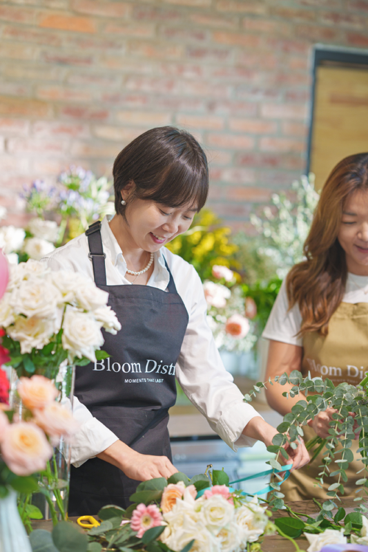 Two women working with flowers 