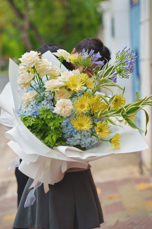Person holding a bouquet of flowers